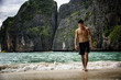 © theartofphoto - Full body shot of a handsome young man standing on a beach in Phuket Island, Thailand, shirtless wearing boxer shorts, showing muscular fit body