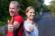 © WavebreakMediaMicro - Smiling athletic couple showing thumbs up
