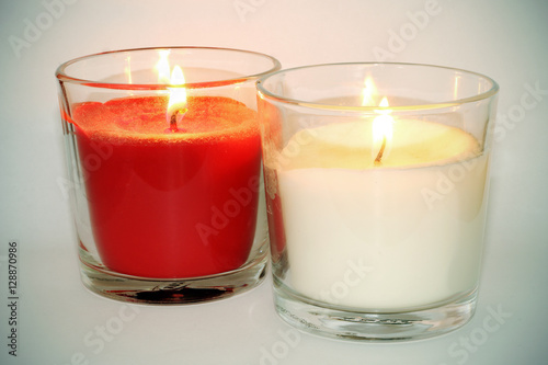 Velas blanca y roja con llama encendida sobre fondo blanco - Buy this stock  photo and explore similar images at Adobe Stock | Adobe Stock