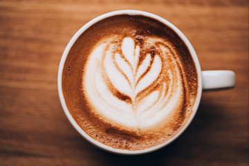 Cup of cappuccino on wooden table