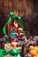 Wall Mural - Christmas composition, Tangerines, pine Cones, Snow,decor, Bunch of Cinnamon, Walnut.Brown Wooden Background.Vintage old lantern.New Year Card