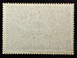 Old posted stamp reverse  side with the edge of the sheet. Texture of paper.