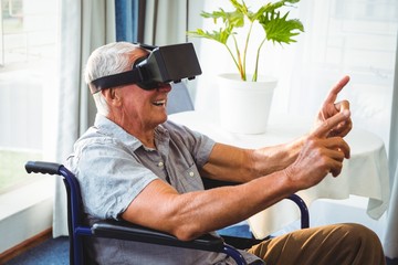 senior man in a wheelchair using a virtual reality device