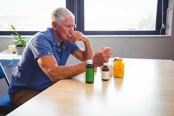 Wall Mural - senior man holding medicine