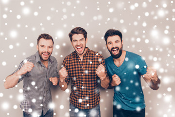 Poster - Three handsome screaming men showing their fists on xmas backgro