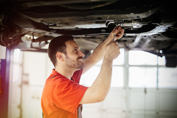 Wall Mural - Car mechanics working and maintaining car