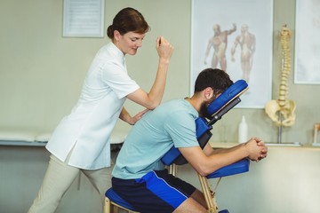 Wall Mural - Physiotherapist giving back massage to a patient