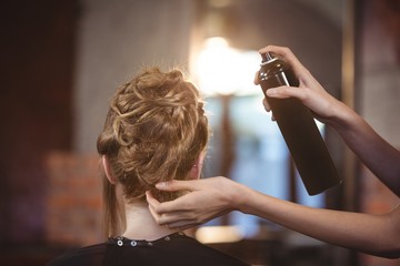 female hairdresser styling customers hair