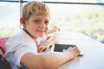 Poster - Schoolkid using digital tablet in classroom