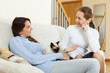 © JackF - Daughter and mother gossiping on sofa