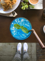 Canvas Print - Selfie of shoes with blue drink