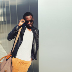 Wall Mural - Fashion african man model posing wearing a sunglasses and black