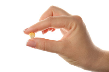 Sticker - Female hand holding a corn grain on white background