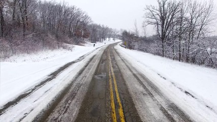 rise above slippery roads and bad weather conditions. the viewer first drives down a slippery, icy w