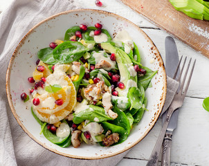 Salad with chicken, orange, spinach and pomegranate seeds. Healt