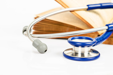 stethoscope and books on white background.