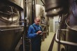 © WavebreakMediaMicro - Owner using digital tablet at brewery