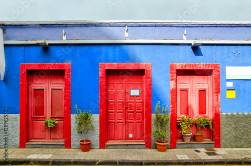 Blue House With Three Red Doors In The Old Town Of San