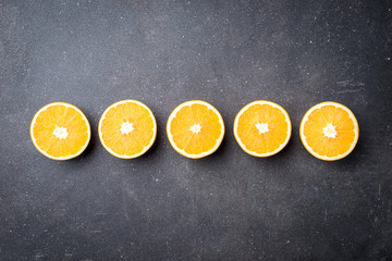 Sticker - Fresh oranges on dark stone table. Top view