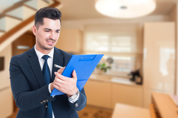 Young realtor writing on clipboard