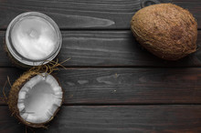 Coconut With Coconut Oil In Jar On Wooden Background