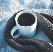 Cup of coffee surrounded the warm scarf on the wooden table in winter time