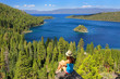 Young woman enjoying the view of Emerald Bay at Lake Tahoe, Cali