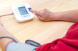 Blood pressure digital pulse monitor. Woman measuring her blood pressure and hearth rate. Health.
