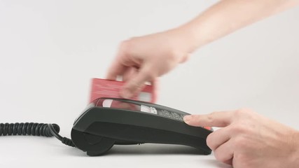 Poster - Crop of female hands press the buttons and swipe credit card at payment terminal. Close-up shot on white background