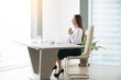 © fizkes - Young woman meditating at the modern office desk, finding a time in over-packed schedule, yoga as a habit and necessary requirement, preparing for a productive work, freedom of religion, of belief
