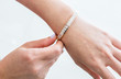 © Theerawat - beautiful bracelet with diamonds and pearls on the hand of the bride