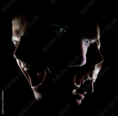 Fotografía Dark portrait of a man with green eyes concept anger agony disheartened force