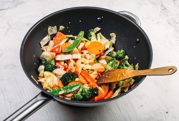 Tasty vegetable dish with broccoli and colorful peppers cooked in oil stained asian wok recipe 