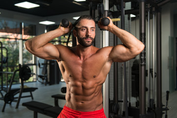  Hispanic Man Exercising Triceps In The Gym