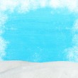 Christmas blue wooden background with snowfall and snowdrift. View with copy space