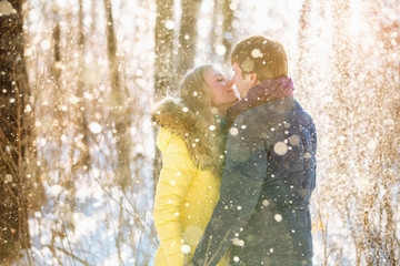 A loving couple walking in winter park