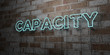 CAPACITY - Glowing Neon Sign on stonework wall - 3D rendered royalty free stock illustration.  Can be used for online banner ads and direct mailers..