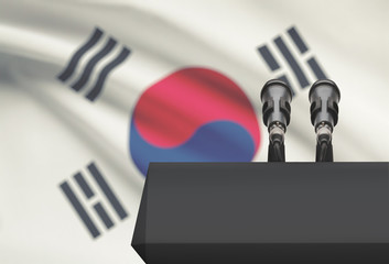 Pulpit and two microphones with a national flag on background - South Korea