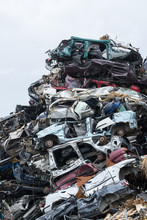 Dumping Ground. Scrap Metal Heap. Compressed Crushed Cars Is Returned For Recycling. Iron Waste Ground In The Industrial Area. Stacked Automobile