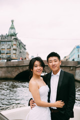 Wall Mural - Bride and groom are floating on a boat on the city's rivers and canals