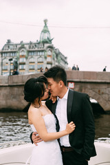 Wall Mural - Bride and groom are floating on a boat on the city's rivers and canals