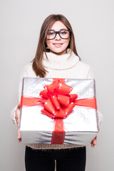 young woman in sweater with small gift