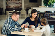 © romankosolapov - Family Enjoying tea In Cafe Together