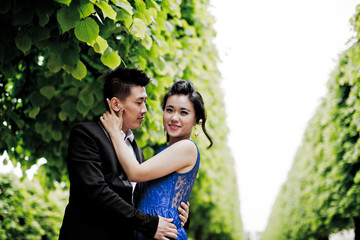 Wall Mural - Bride and groom on their wedding day outdoors. Chinese bride in a blue dress