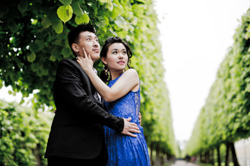 Wall Mural - Bride and groom on their wedding day outdoors. Chinese bride in a blue dress