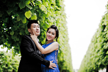 Wall Mural - Bride and groom on their wedding day outdoors. Chinese bride in a blue dress