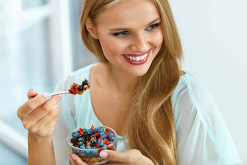 Wall Mural - Healthy Diet. Woman Eating Cereal, Berries In Morning. Nutrition