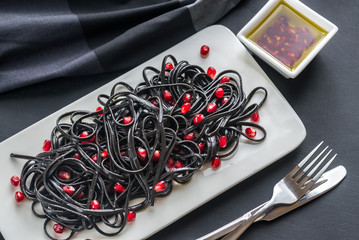 Sticker - Black pasta with pomegranate seeds