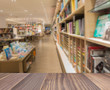 © kaew6566 - Wooden board empty table in front blurred photo of book store