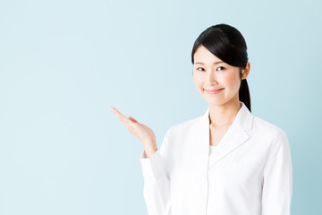 Wall Mural - portrait of young asian nurse isolated on blue background